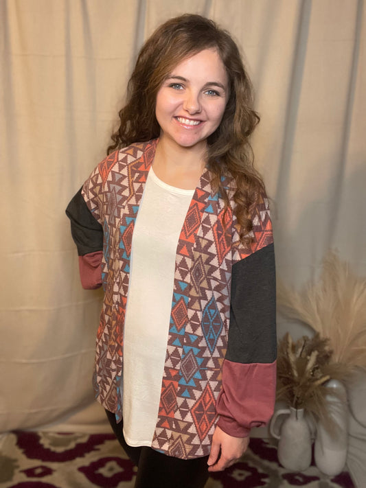 Knit open front features patchwork print with colorblock sleeves. Loose fit, stretchy, soft lightweight fabric. Multi-Color.