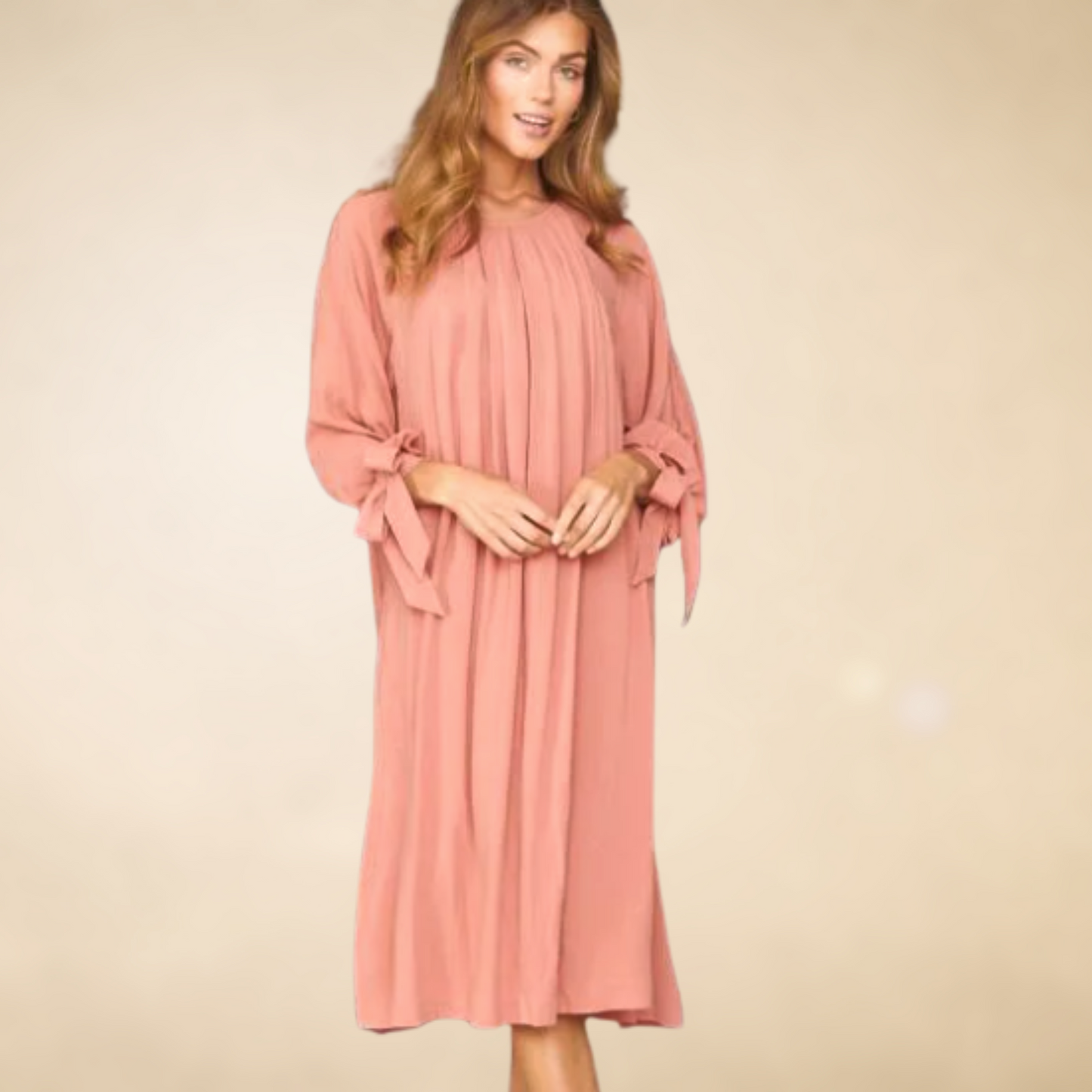 Mauve pleated front dress with long slleves that have functional bows at the  wrist  below the knees hem with slits onthe sides.