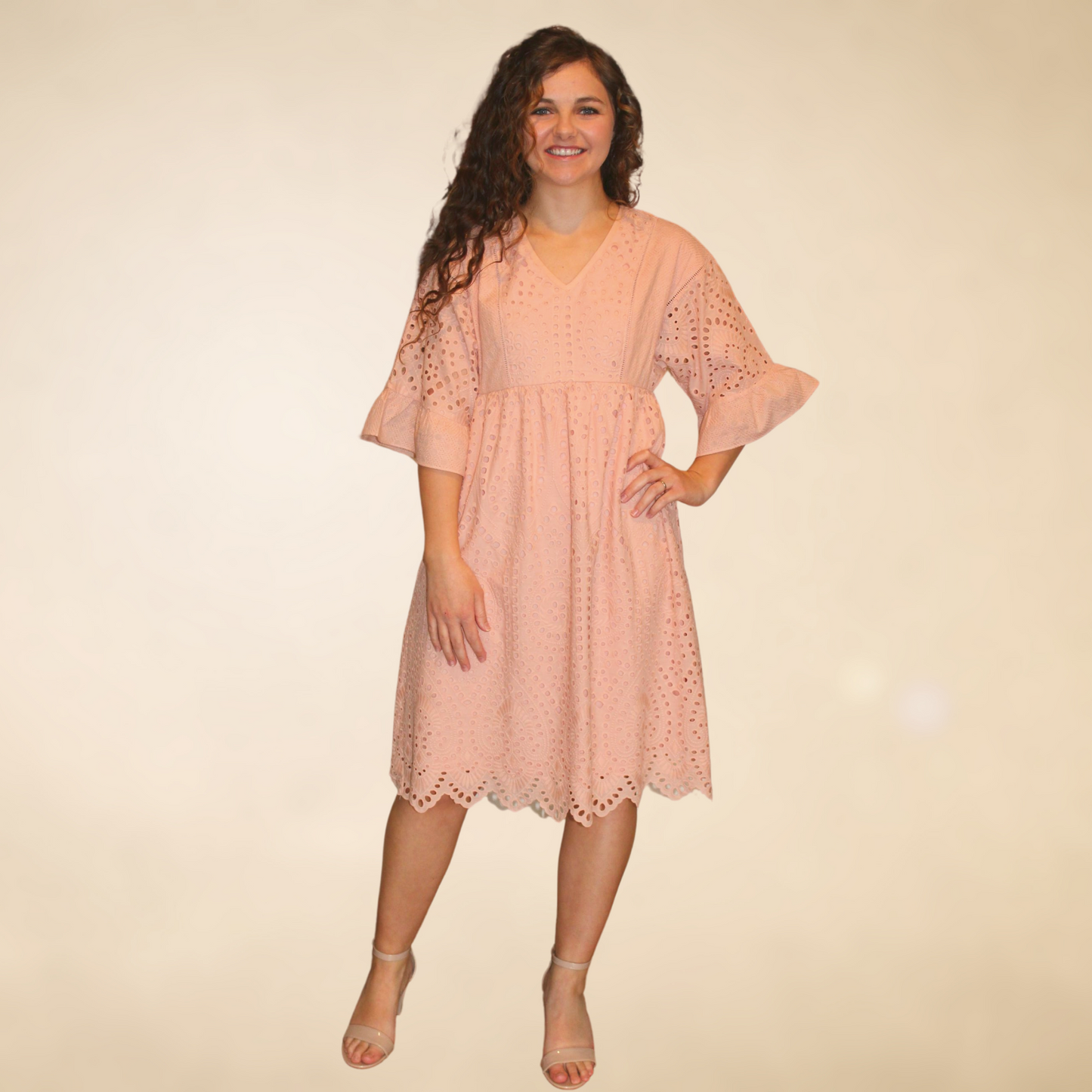 Blush colored eyelet detailed dress with ruffled three quarter length sleeves vneck lline scalloped hemline