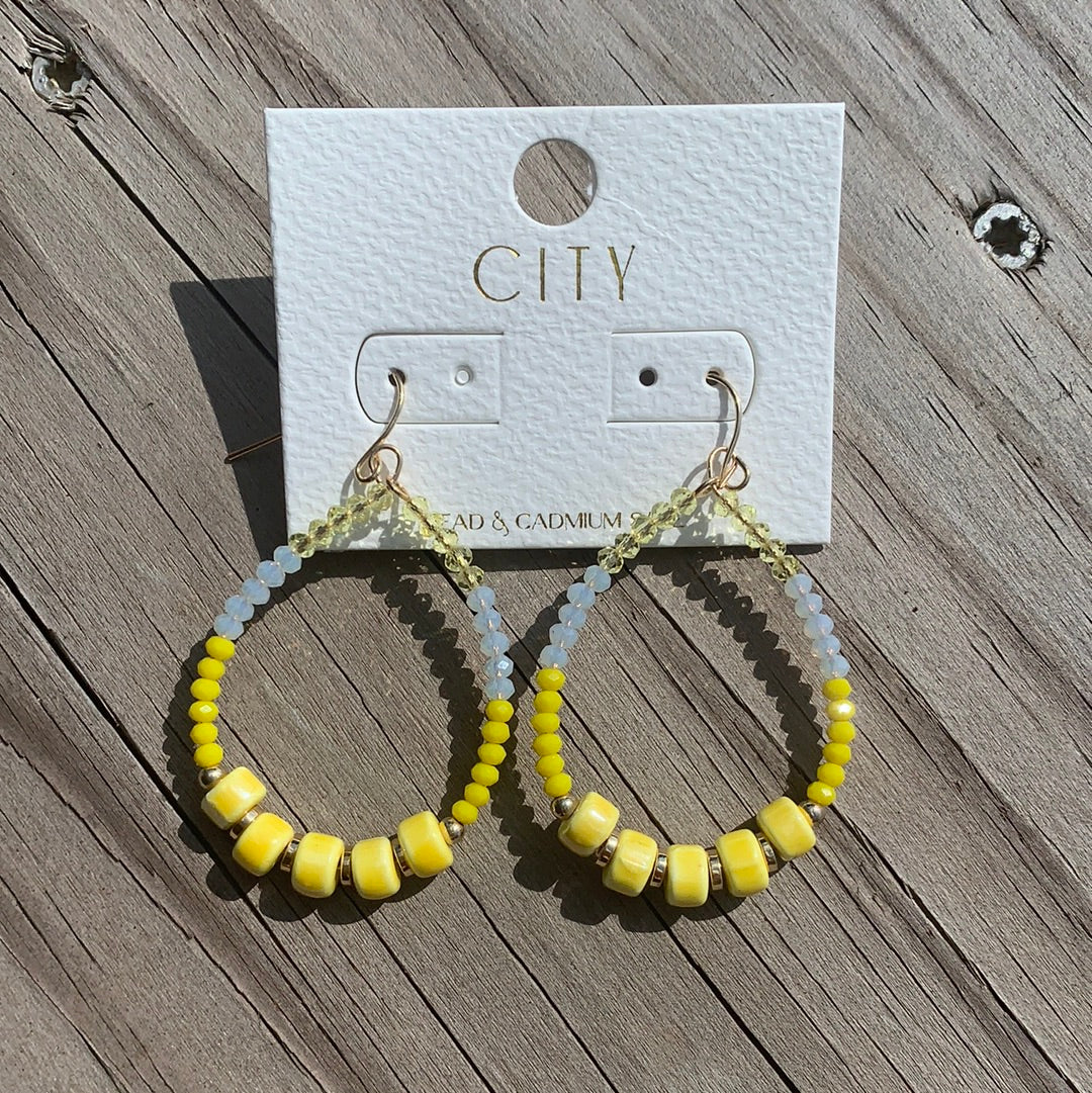 Yellow beaded hoop earrings with a little bit of a sparkle detail.