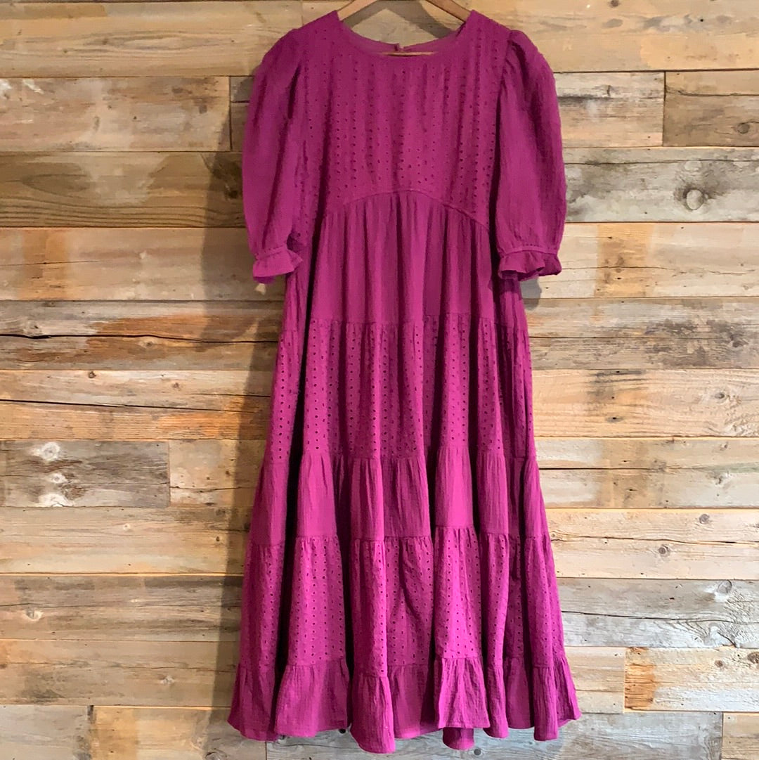 Deep purple eyellet detailed dress with elbow length sleeves with elastic  tiered skirted bottom with ruffle and  round neckline length below the knee